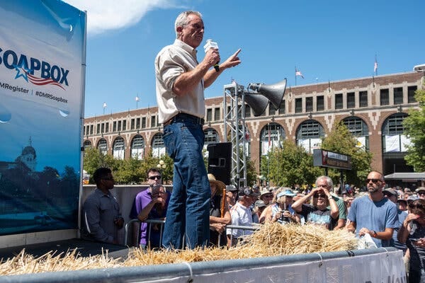 Robert F. Kennedy Jr. speaking at the Iowa State Fair in August, with people watching in the background. 