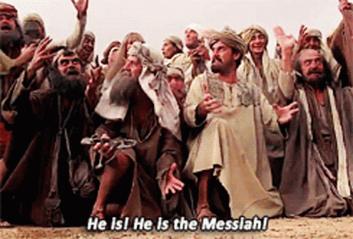 GIF from Monty Python's "Life of Brian" with a crowd of people in ancient looking outfits screaming excitedly "he is! He is the messiah!" And bowing.