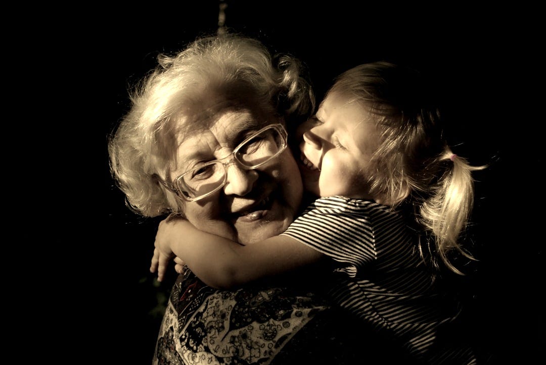 woman in black and white striped shirt hugging girl in black and white striped shirt woman in black and white striped shirt hugging girl in black and white striped shirt