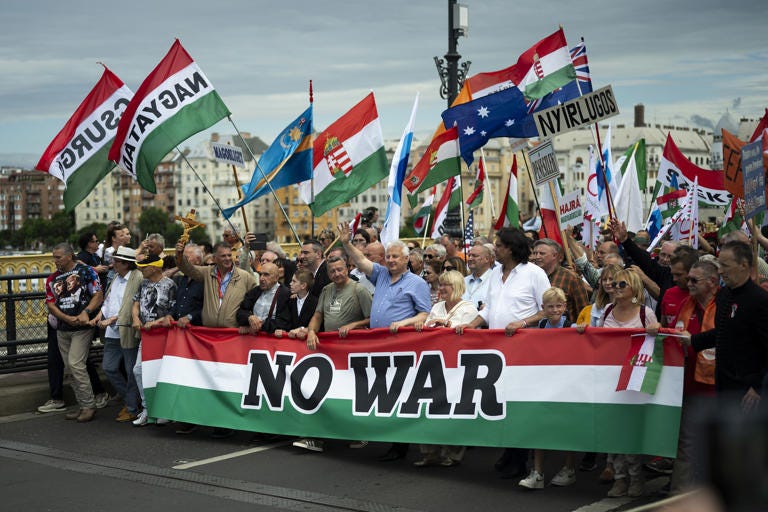 People march during a rally in support of Hungary's Prime Minister Viktor Orbán and his party in Budapest, Hungary on Saturday, June 1, 2024. Orbán, whose 14 years in power make him the European Union's longest serving leader, has focused his campaign for the June 9 European Parliament elections on the war in Ukraine, portraying his domestic and international opponents as warmongers who seek to involve Hungary directly in the conflict. (AP Photo/Denes Erdos)