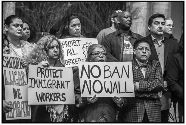 A group of people holding signs

AI-generated content may be incorrect.