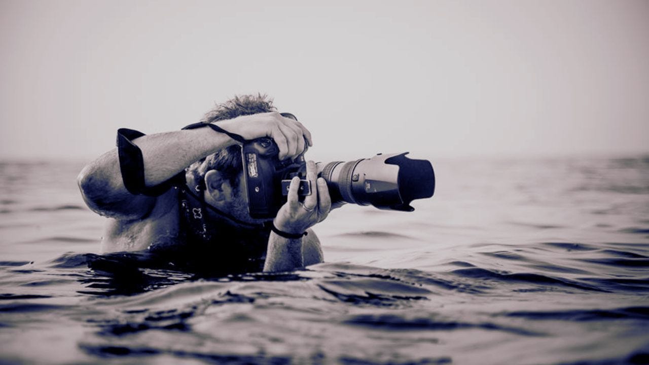 photographer in water - Do whatever it takes by Chase Jarvis, founder of CreativeLive.