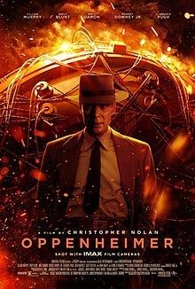 Cillian Murphy as J. Robert Oppenheimer stands in front of the ignited "Gadget" nuclear bomb.