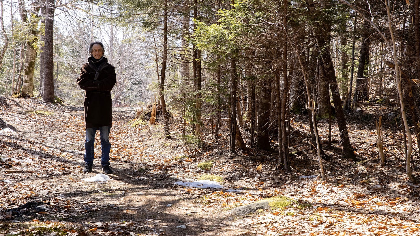 man standing in woods in winter coat Nova Scotia south shore