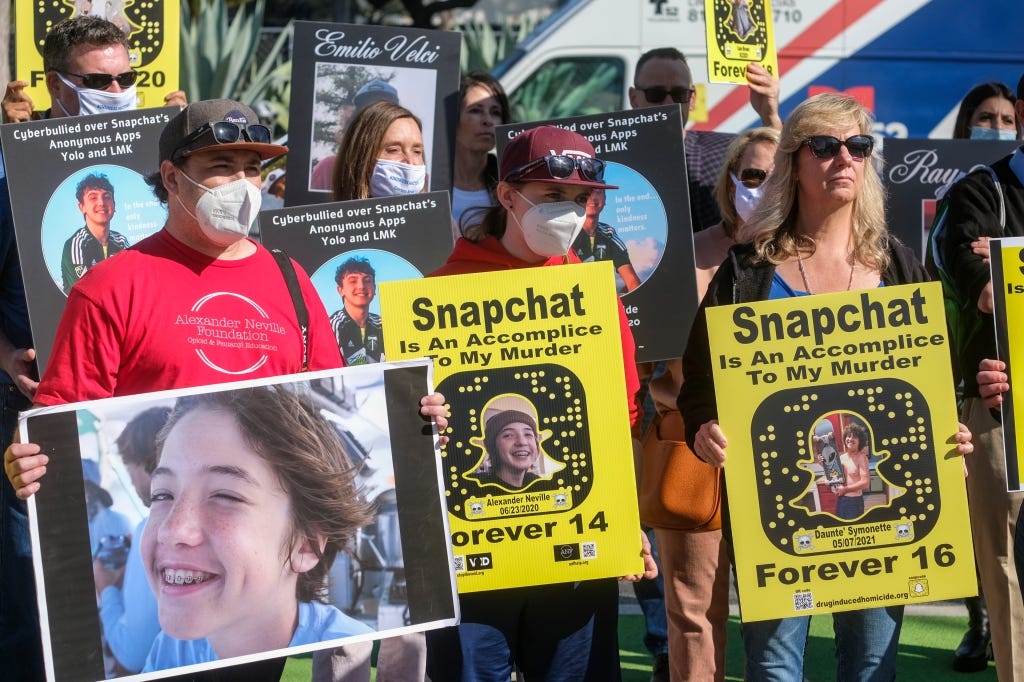 Familes of fentanyl overdoses are pictured protesting Snapchat