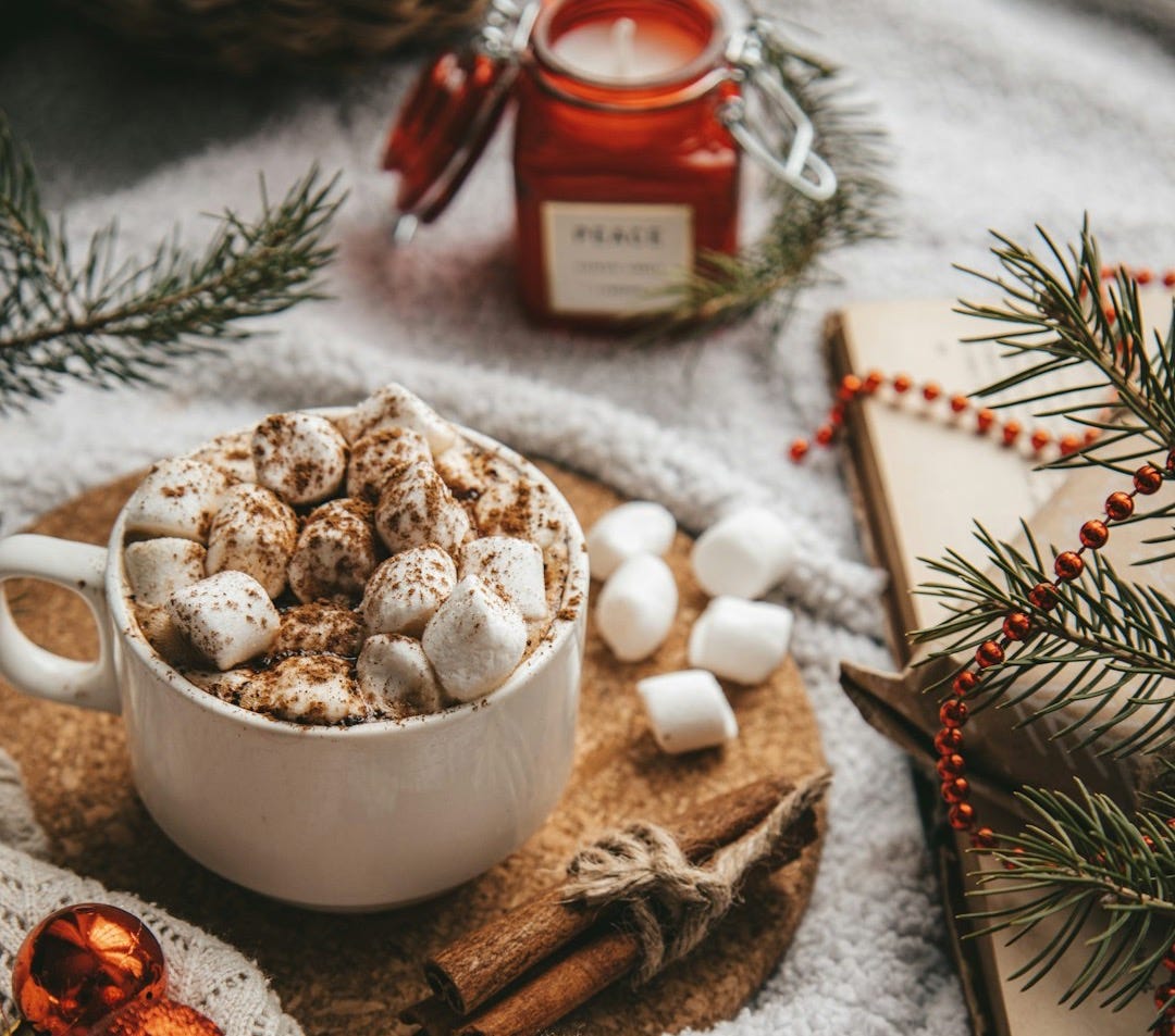 white ceramic mug with brown and white liquid inside