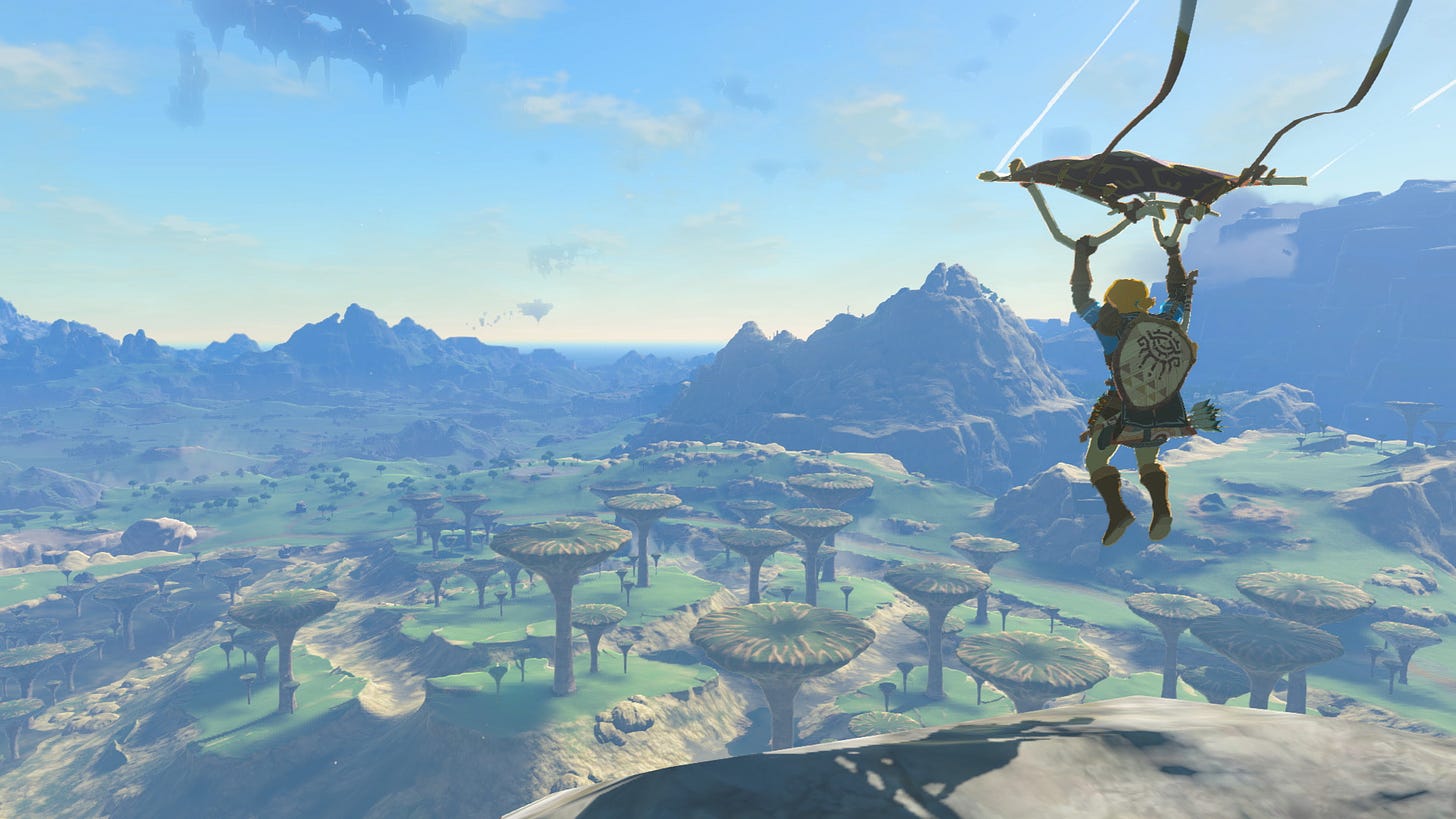 Link rides paraglider above fantasy landscape with a triforce shield on his back