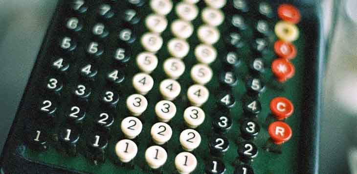 Photo of the number keys on an old mechanical calculating machine.