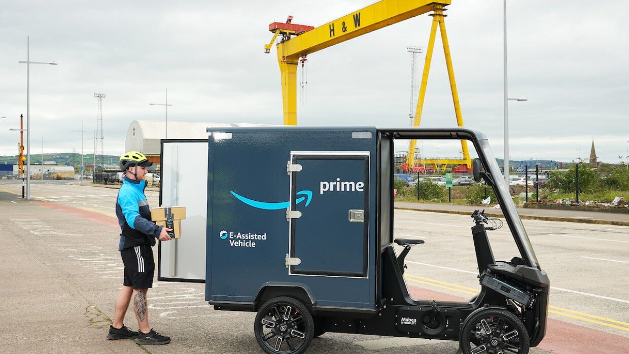 An Amazon e-cargo bike being loaded in front of a Harland and Wolf crane in Belfast