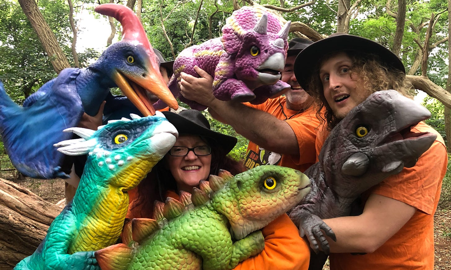 people holding toy dinosaurs