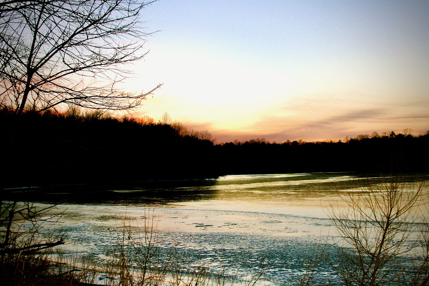 Sunset on a frozen winter lake.