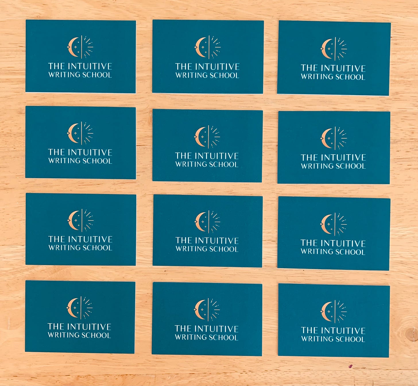 The Intuitive Writing School business cards lined up in a grid of 12