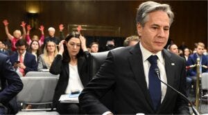 U.S. Secretary of State Antony Blinken looks on as protestors hold their hands in the air during a Senate Appropriations Committee hearing to examine the national security supplemental request, on Capitol Hill, Oct. 31, 2023.