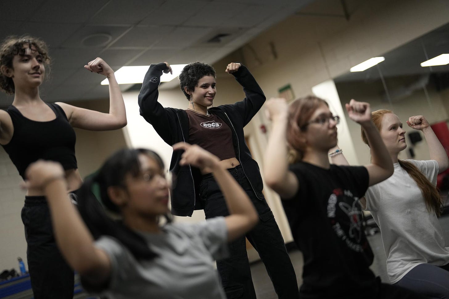 Gaby Batista, 19, center, an anthropology major at New College of Florida learns a dance routine to perform for fun along with other students, Wednesday, March 1, 2023, in Sarasota, Fla. Batista says the student body at New College is tight-knit and accepting, nothing like at her high school in Broward County, Florida where she was was teased for being different, for having hobbies like anime and K-pop and for an expressive style of dressing. (AP Photo/Rebecca Blackwell)