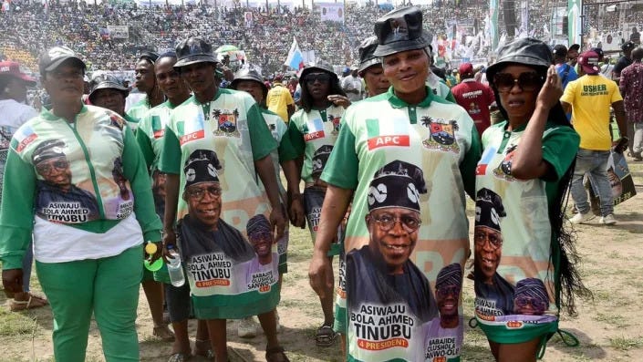 Supporters wear outfits depicting a campaign poster showing presidential candidate of All Progressives Congress (APC) Bola Tinubu and runningmate Abdullahi Shettima, during a party campaign rally at Teslim Balogun Stadium in Lagos, on November 26, 2022