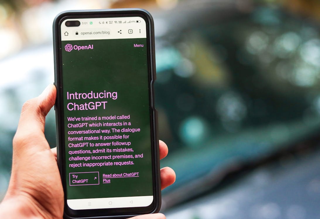 Free Webpage of ChatGPT, a prototype AI chatbot, is seen on the website of OpenAI, on a smartphone. Examples, capabilities, and limitations are shown. Stock Photo