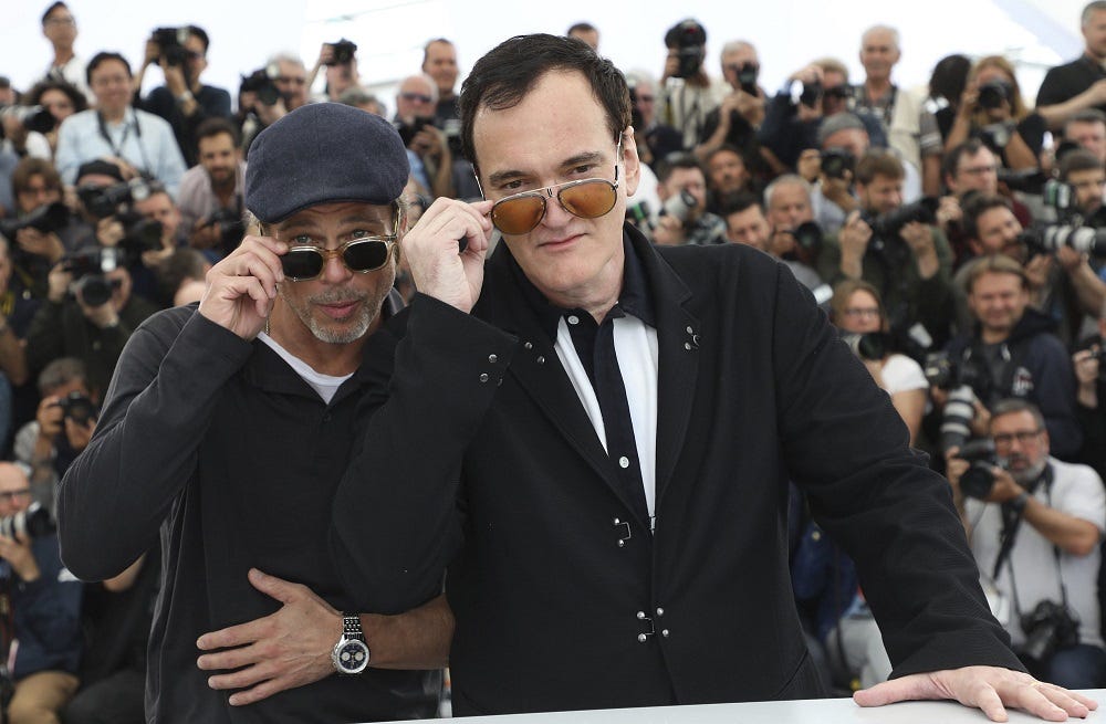 brad pitt tips glasses with quentin tarantino cannes