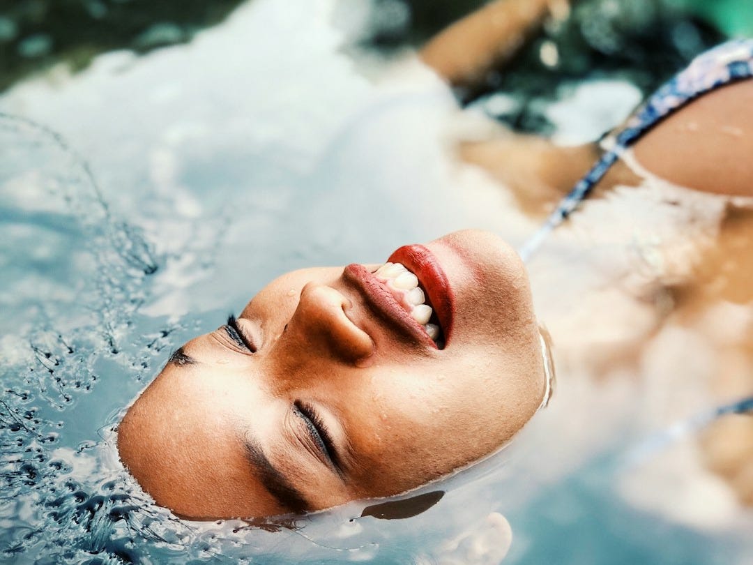 floating woman on body of water