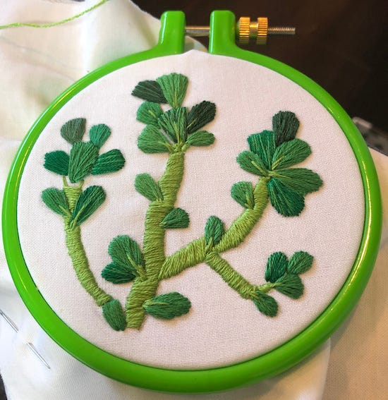 embroidered purslane, green floss on white cotton, in a green hoop