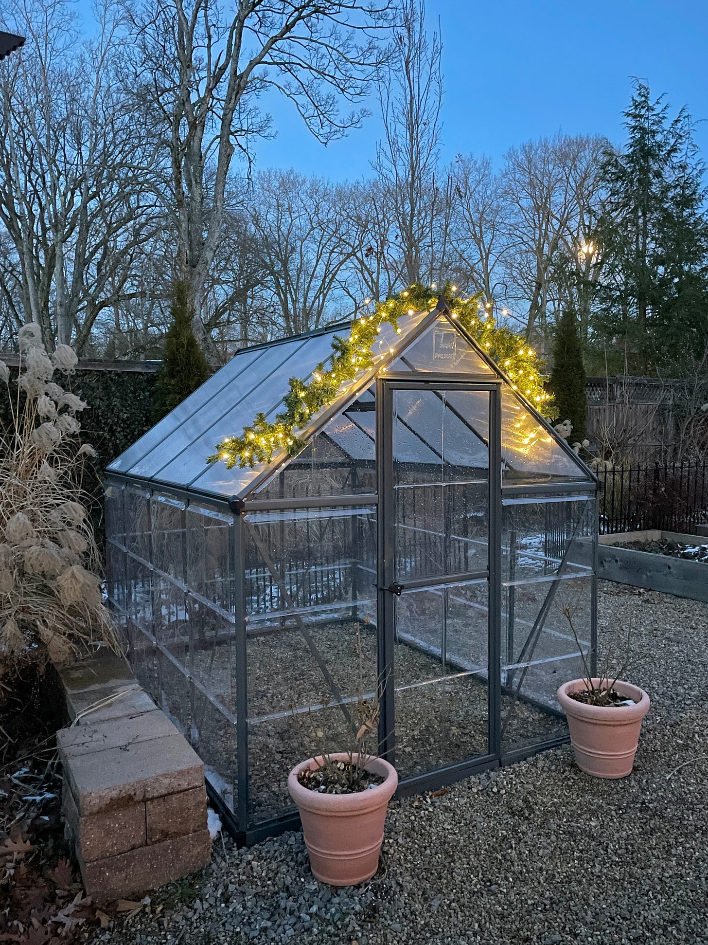 Some lights on the empty greenhouse that is waiting for its pots. 