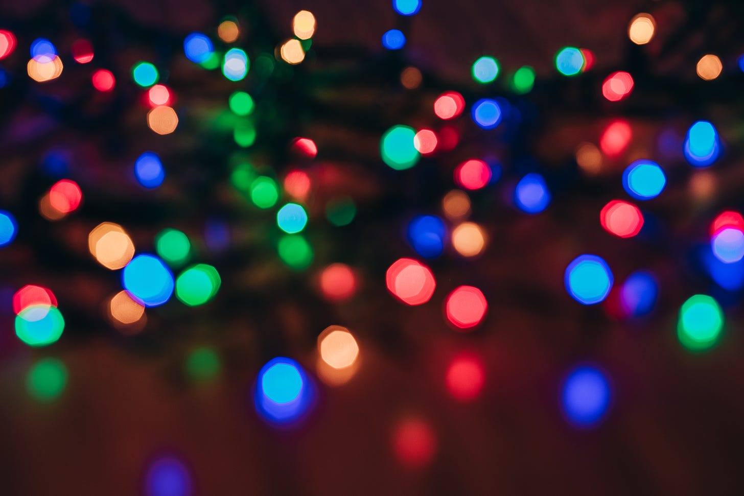 Blurry view of an illuminated strand of multicolored holiday lights