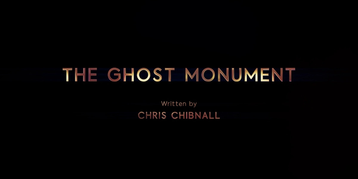 This image shows the title card of Doctor Who Series 11's second episode ("The Ghost Monument"). The episode's title appears in gold type above writer Chris Chibnall's writing credit. This image shows the title card of Doctor Who Series 11's second episode ("The Ghost Monument"). The episode's title appears in gold type above writer Chris Chibnall's writing credit.