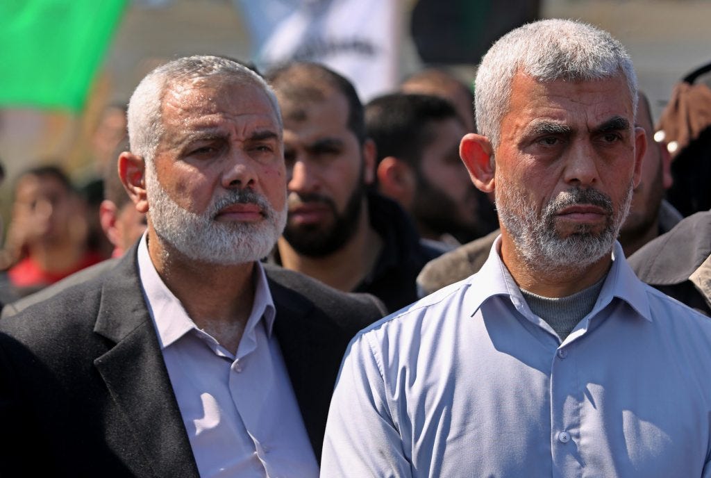 Yahya Sinwar (right) and Ismail Haniyeh (left) attending the funeral of Hamas official Mazen Foqaha in Gaza City on March 25, 2017. (Photo: Ashraf Amra/APA Images)