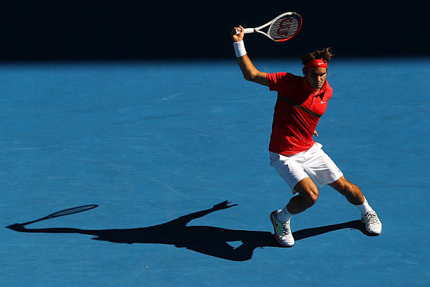 Roger Federer of Switzerland plays a backhand in his quarter final match against Juan Martin Del Potro of Argentina during day nine of the 2012...