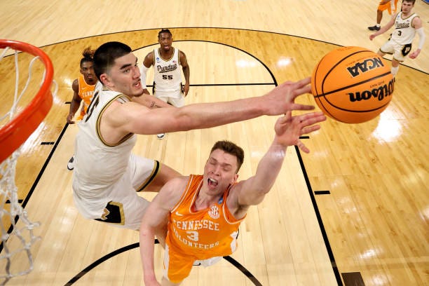 Zach Edey of the Purdue Boilermakers blocks a shot by Dalton Knecht of the Tennessee Volunteers during the second half in the Elite 8 round of the...
