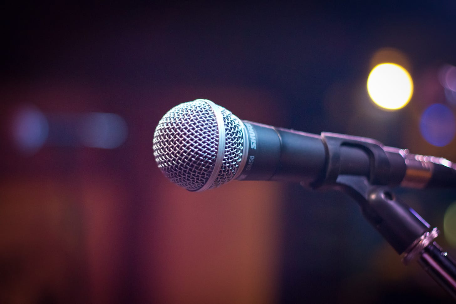 a zoomed in picture of a microphone on a stage. The background is blurred out.