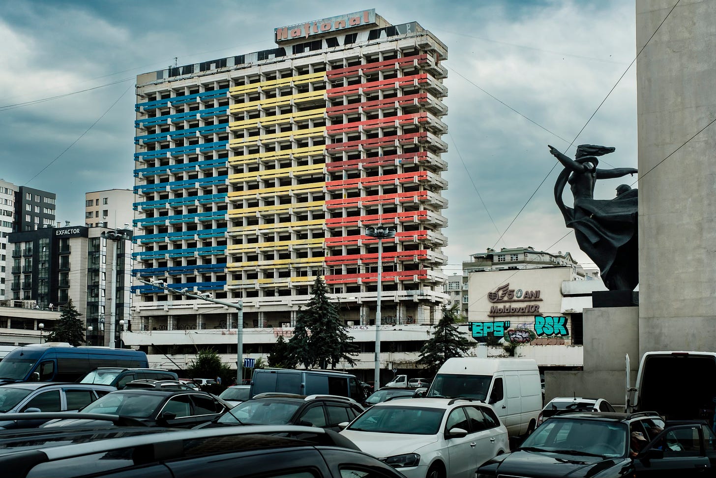 Streets of Chisinau, Moldova: WWII monument, concrete façade painted in blue, yellow and red