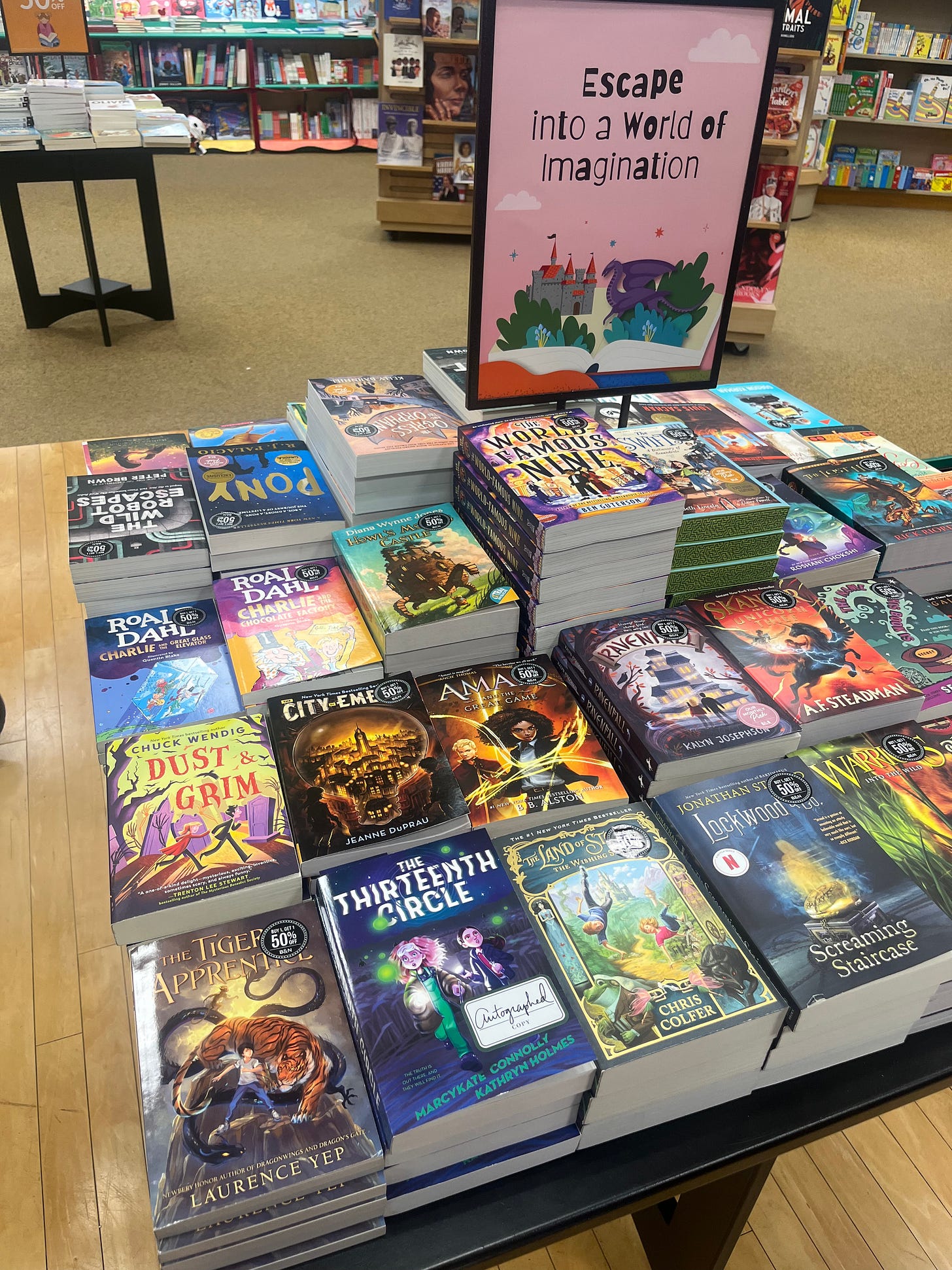 A selection of middle-grade books, including The Thirteenth Circle, on a display table at Barnes & Noble.