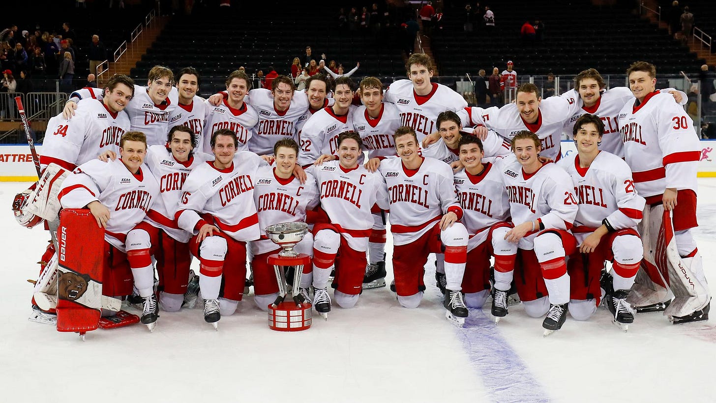 The Cornell men's hockey team celebrates with the Kelley-Harkness Cup after defeating Boston University, 6-4, in the Red Hot Hockey game on Nov. 27, 2021 at Madison Square Garden in New York. (Matt Dewkett/Cornell Athletics)