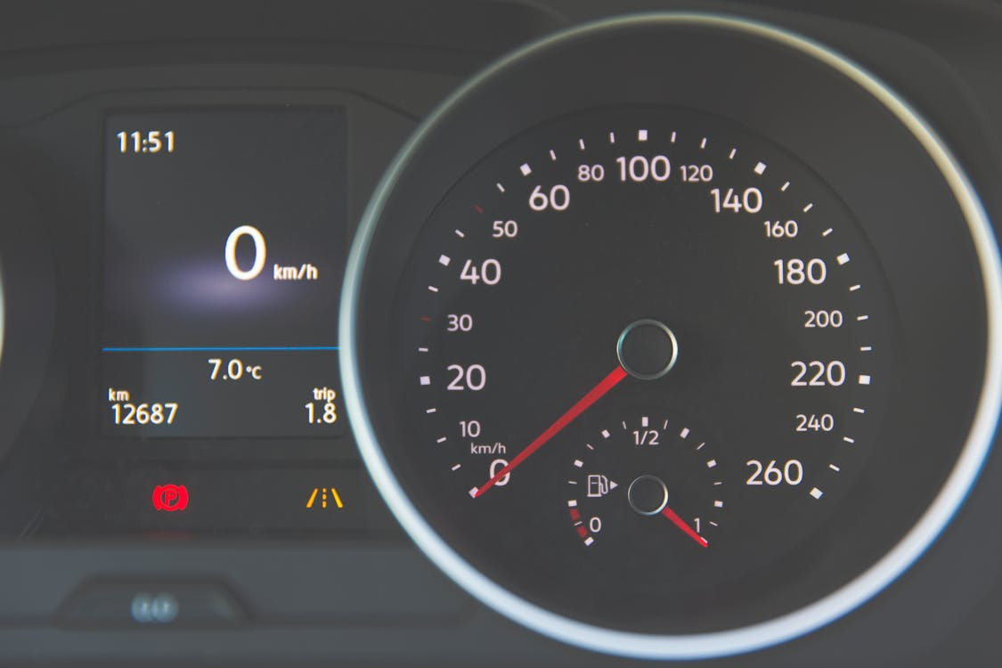 Free Detailed view of a car speedometer showing 0 km/h and fuel gauge with digital display. Stock Photo