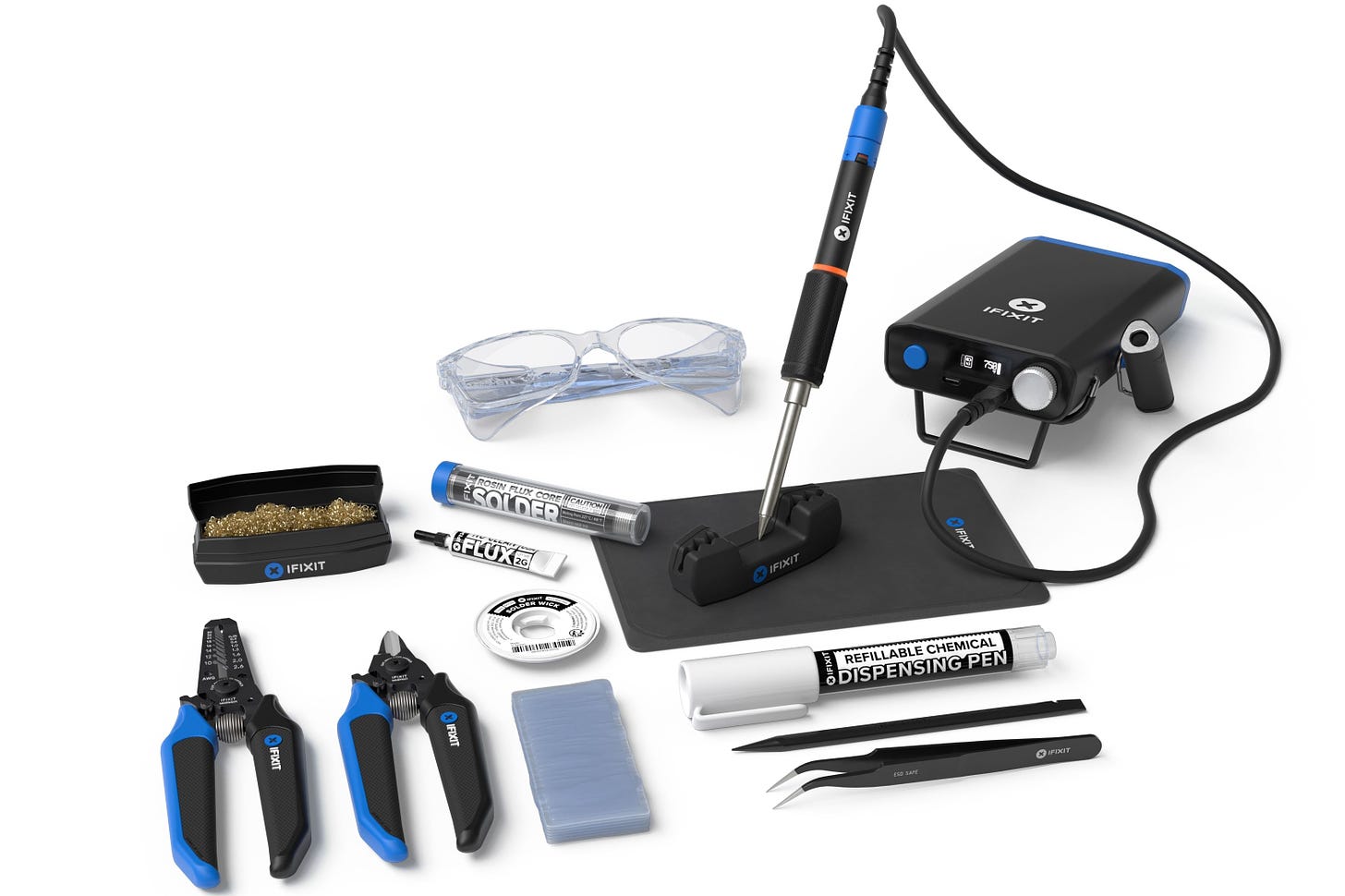 All the tools included in iFixit's FixHub soldering toolkit laid out on a white table.