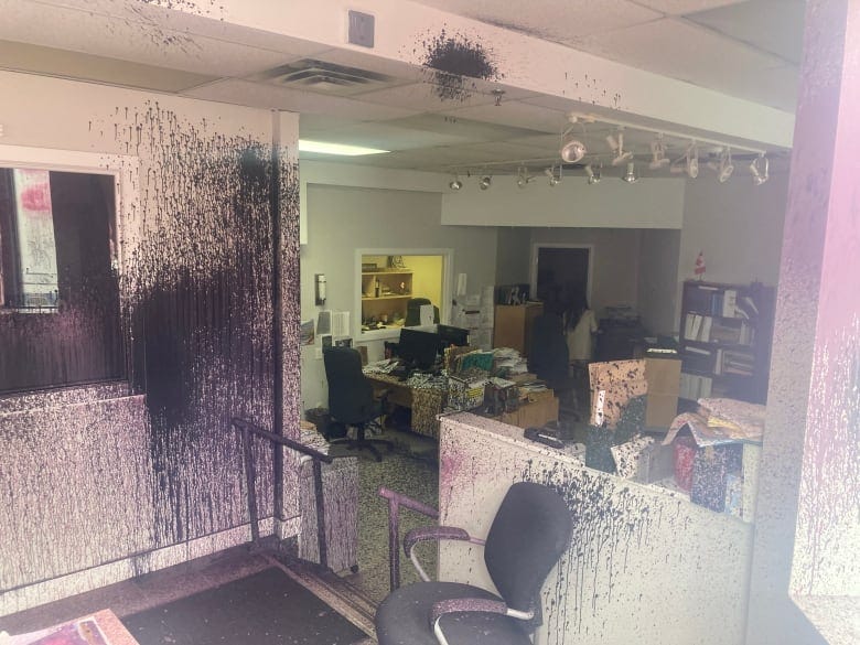 Black and pink paint sprayed on office walls