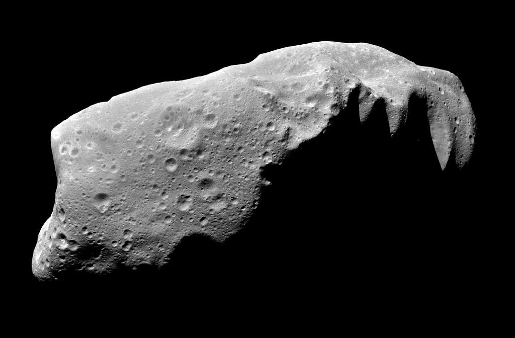 A NASA photograph of the asteroid Ida, showing close up of its irregular shape and crater-pocked surface