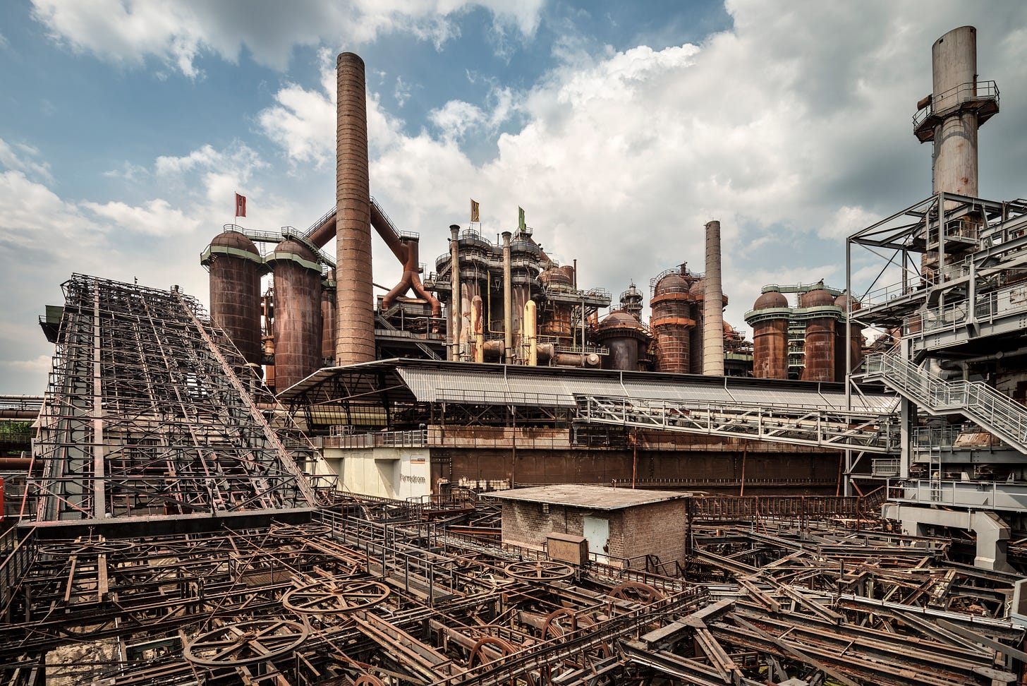 An iron steelworks against a cloudy sky