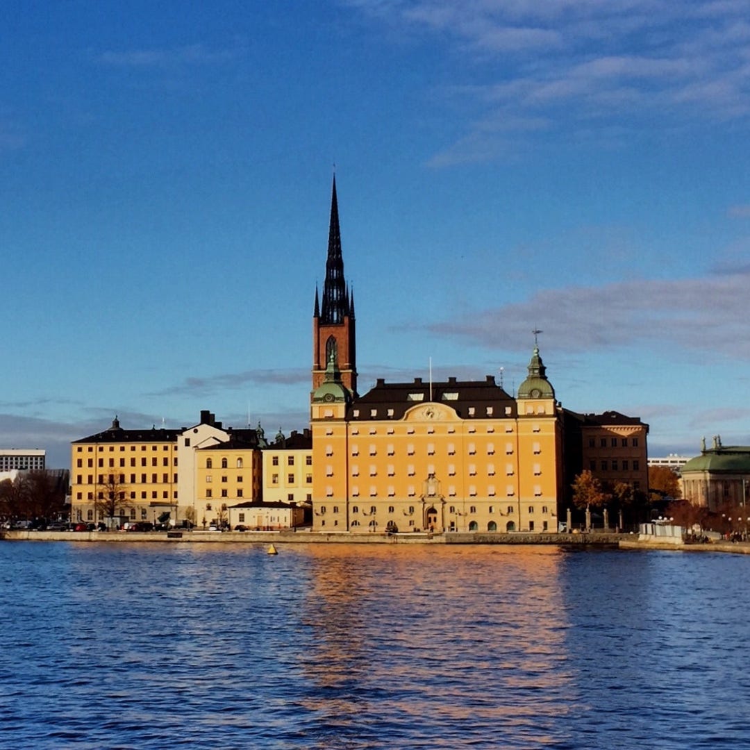 a beautiful view on a sunny day over blue waters of old buildings on an island in Stockholm