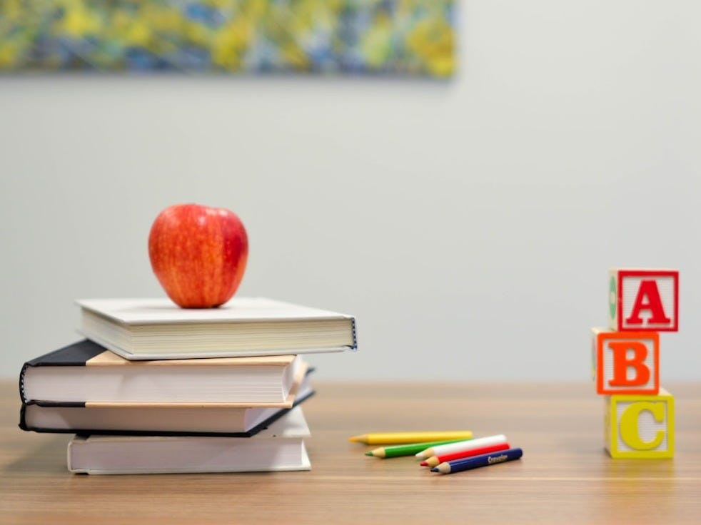 red apple fruit on four pyle books red apple fruit on four pyle books
