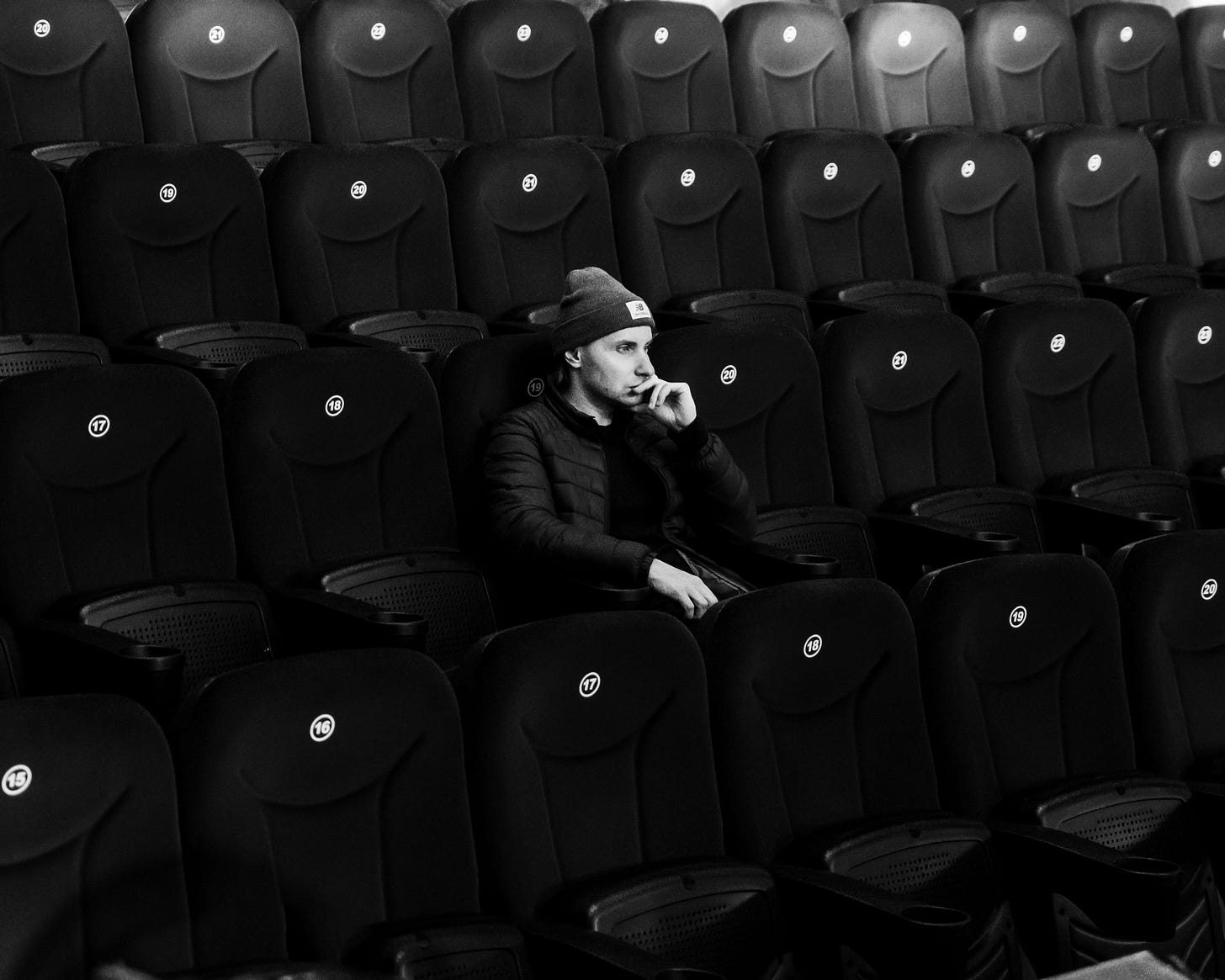 A man sitting alone in a theater