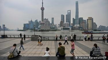 People gather on the Bund along the Huangpu River in Shanghai.