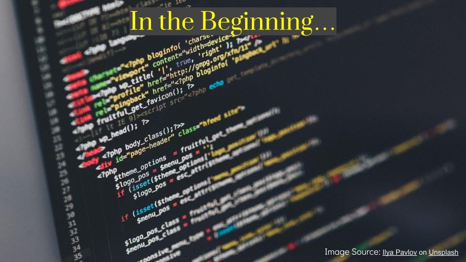 A screen with computer code on it and across the top, it reads, "In the Beginning"