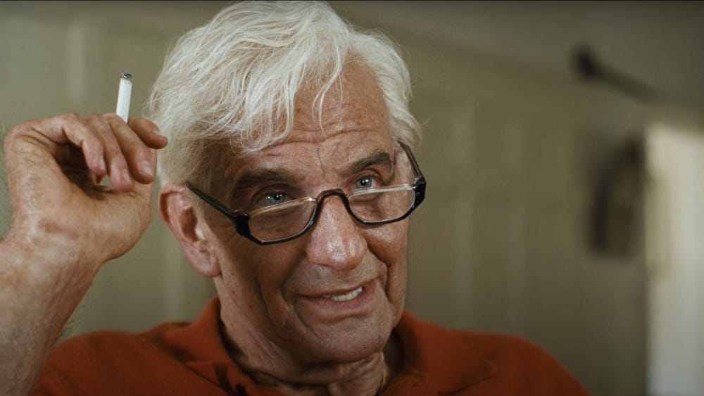 A screenshot from the film Maestro showing the main character at an advanced age