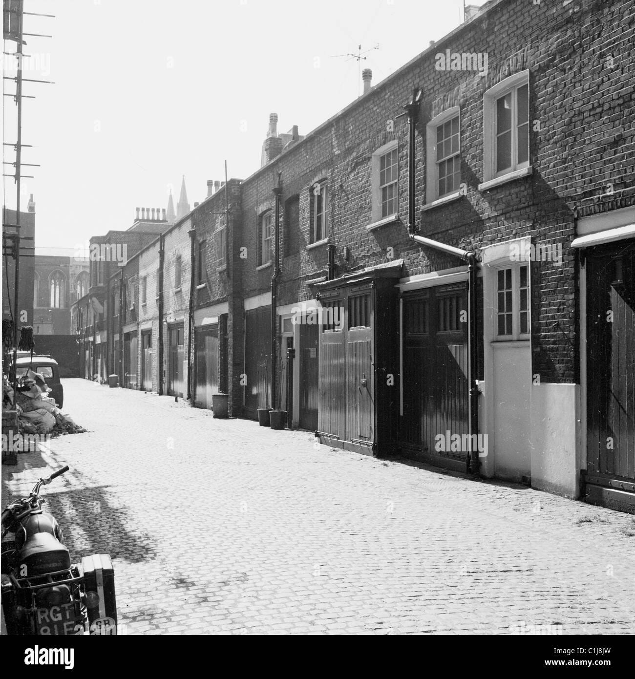 London, 1950s. A cobbled street of mews houses in Central London, with ...