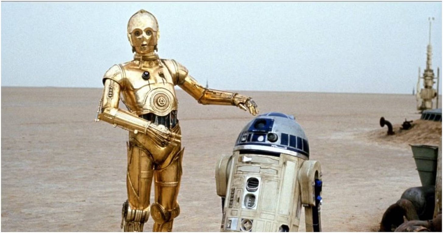 R2-D2 and C-3PO walk through the desert of Tattooine.