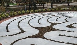one quarter of a large labyrinth. White pathway, surrounded with dark gravel.