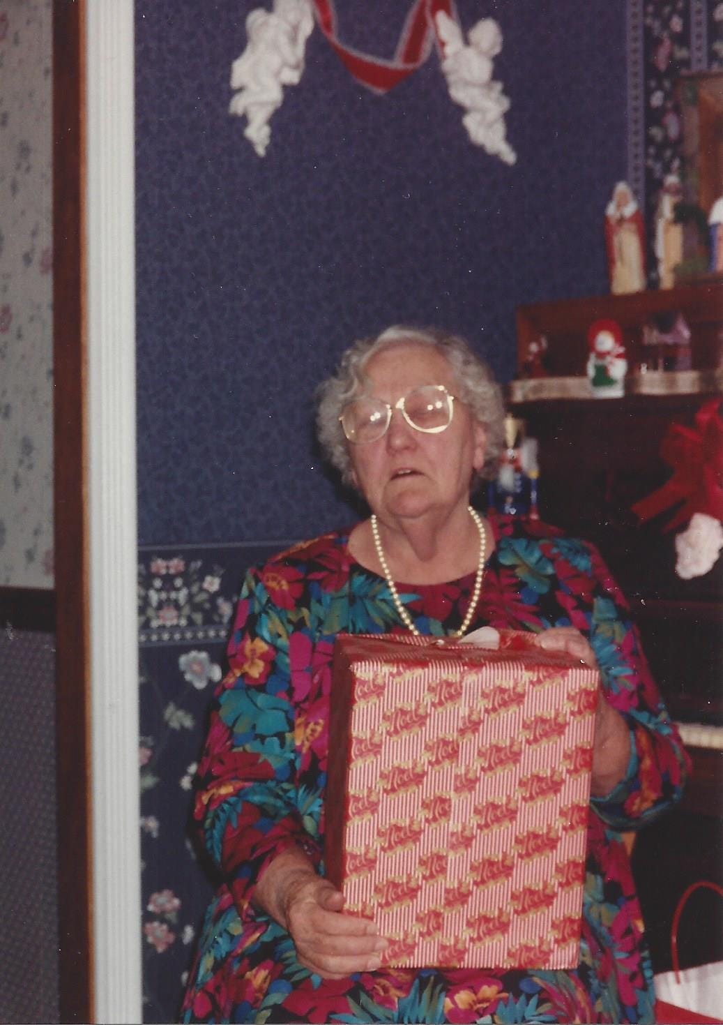 Grandmother exclaims in wonderment upon receiving the perfect Christmas gift