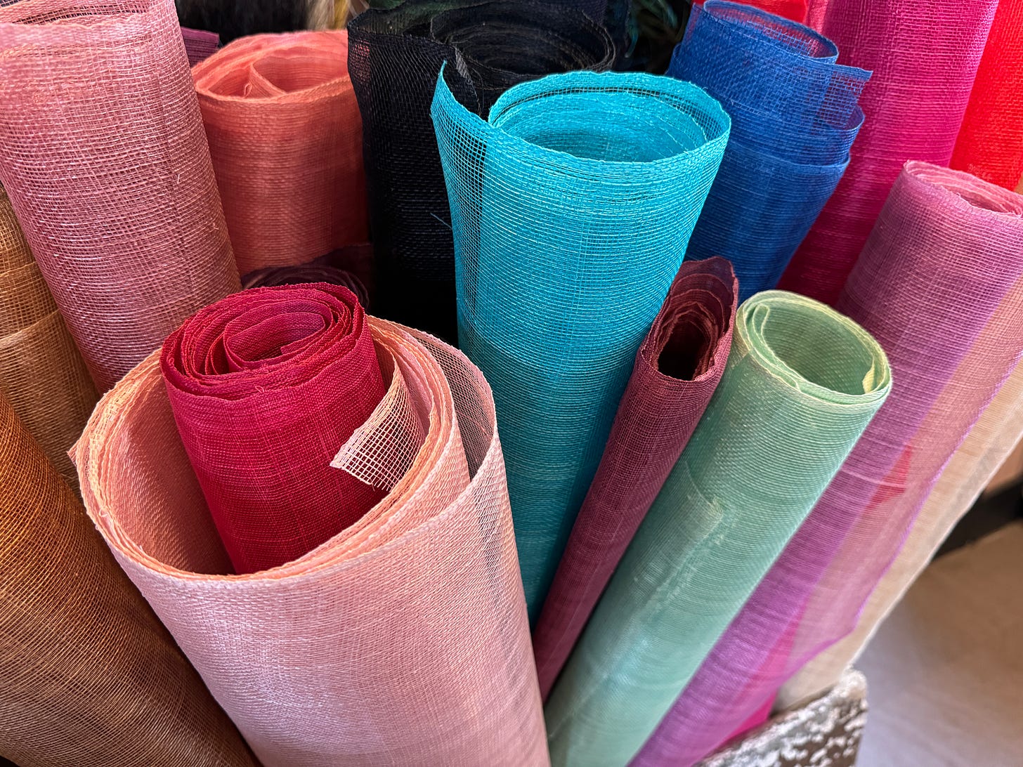 This is an image of rolls of straw, hand-woven in their native areas, including the Philippines.