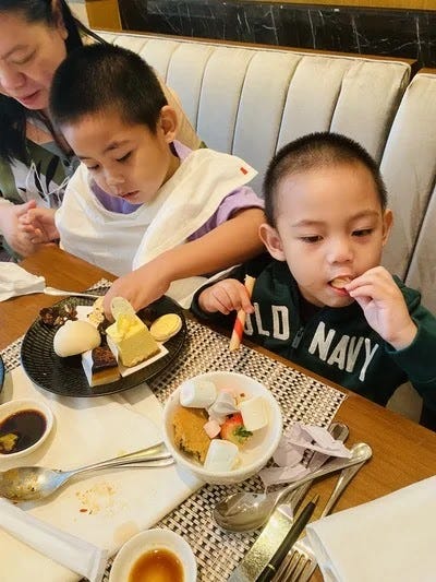 Miguel and Rafa eating sweets at High Street Cafe at Shangri-La The Fort